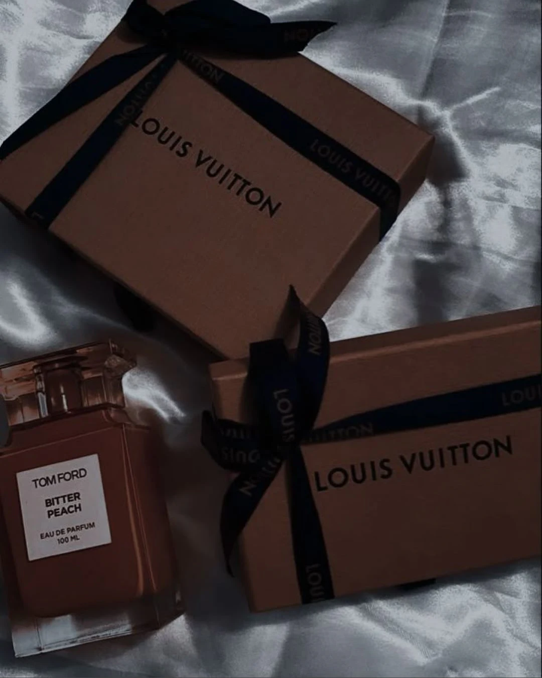 Designer gift boxes and perfume on silk