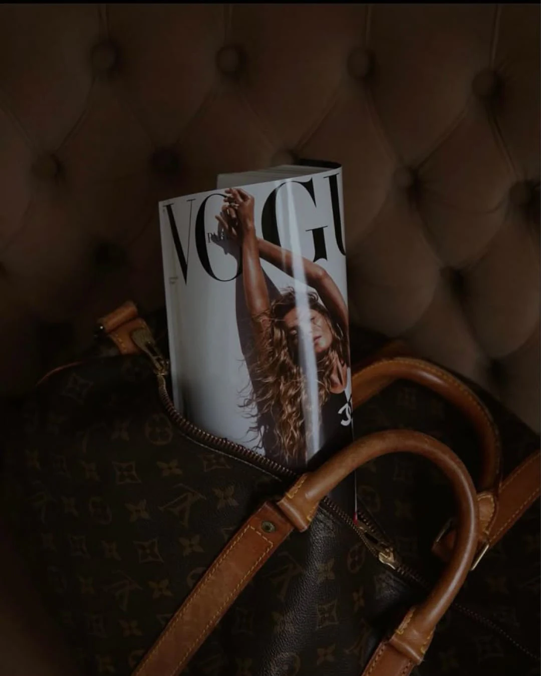 A fashion magazine in a monogram bag